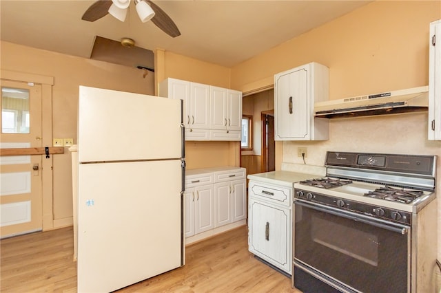 kitchen with white cabinetry, white fridge, range with gas stovetop, and range hood