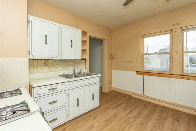 kitchen featuring white cabinetry, sink, and light hardwood / wood-style floors