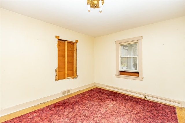 unfurnished room with a baseboard radiator