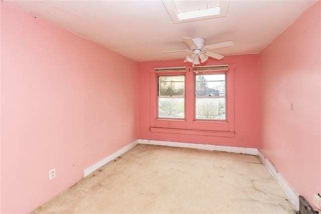 carpeted spare room with ceiling fan