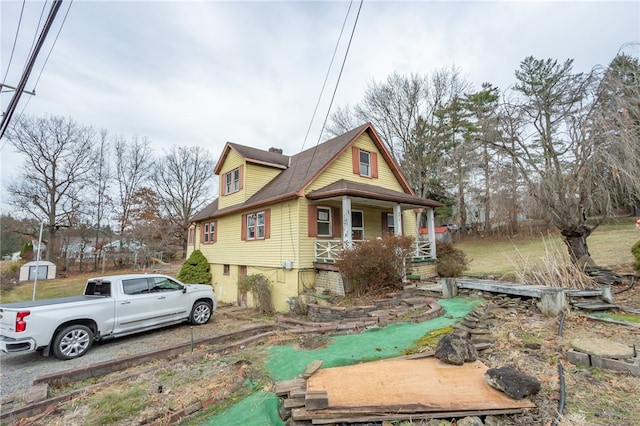 view of side of property with covered porch