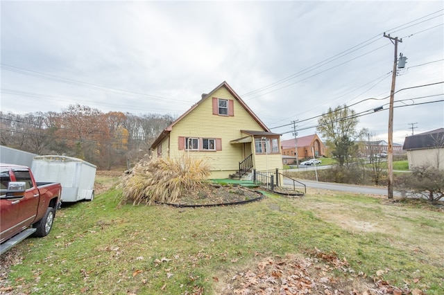 rear view of house featuring a yard