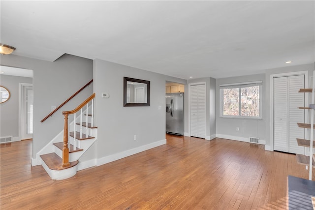 unfurnished living room with wood-type flooring