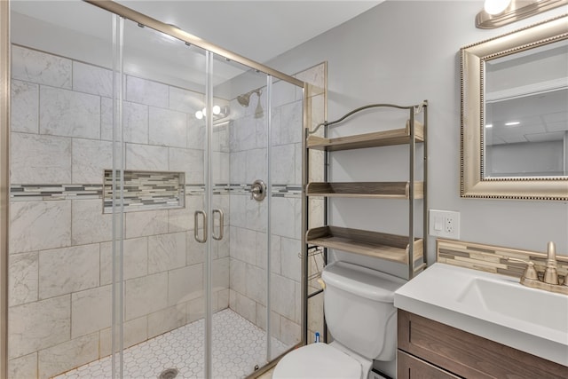 bathroom with toilet, vanity, and walk in shower