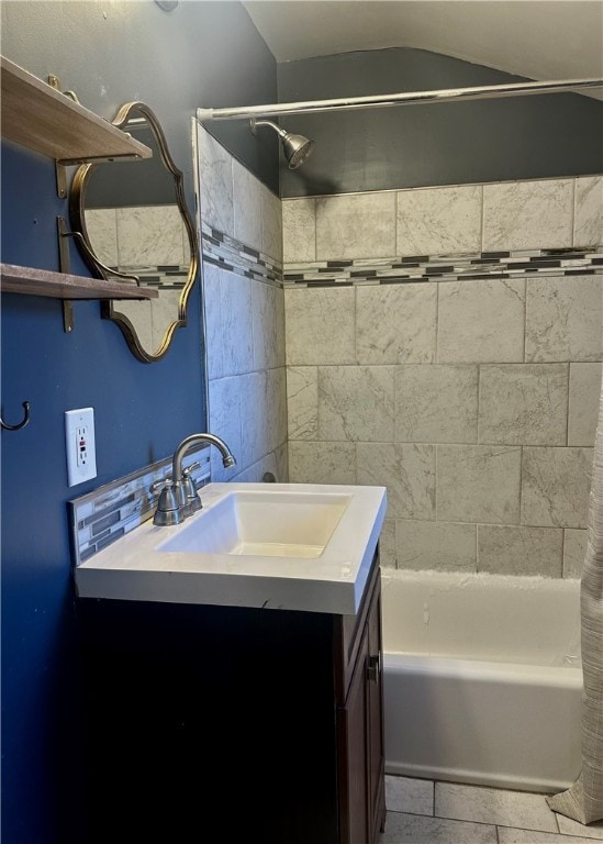 bathroom featuring shower / bath combo and vanity