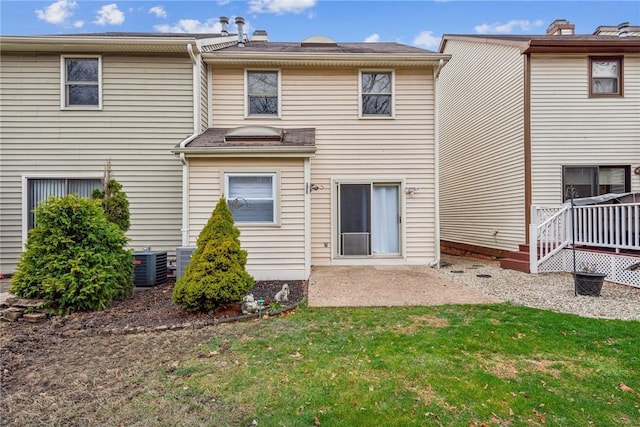 rear view of house featuring a yard, a patio, and central AC unit