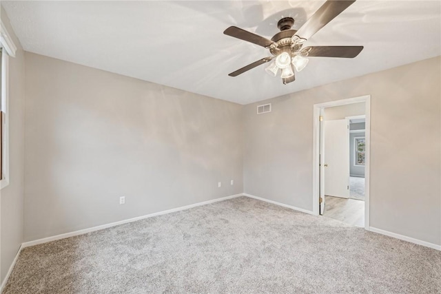 unfurnished room with ceiling fan and light colored carpet