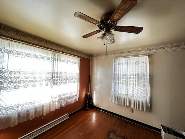 spare room with dark hardwood / wood-style floors and ceiling fan