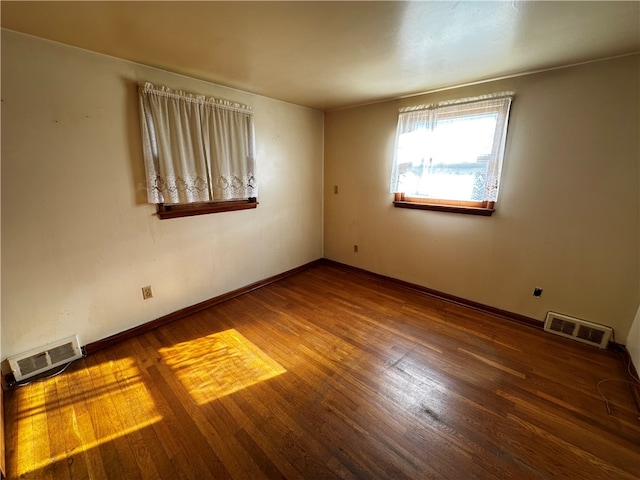 empty room featuring dark hardwood / wood-style floors