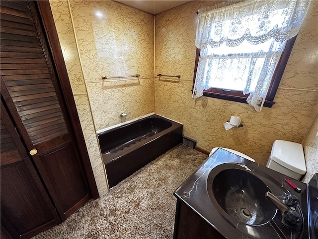 bathroom with toilet and a tub