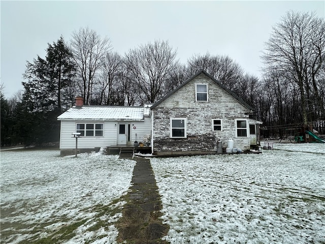 view of snow covered rear of property