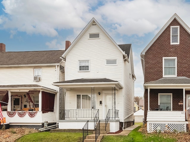 rear view of property featuring cooling unit and a porch