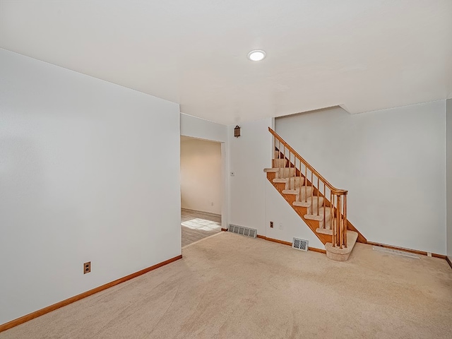 empty room featuring light carpet