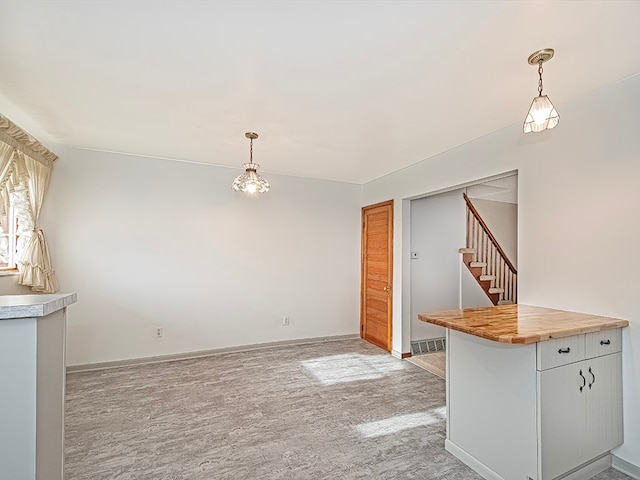 unfurnished dining area with light carpet