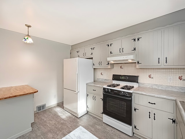 kitchen with hanging light fixtures, tasteful backsplash, hardwood / wood-style floors, white appliances, and white cabinets