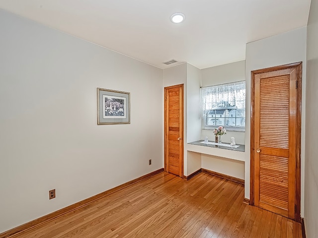 unfurnished bedroom with light wood-type flooring