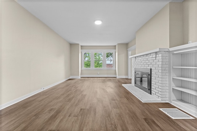 unfurnished living room featuring a fireplace and hardwood / wood-style flooring