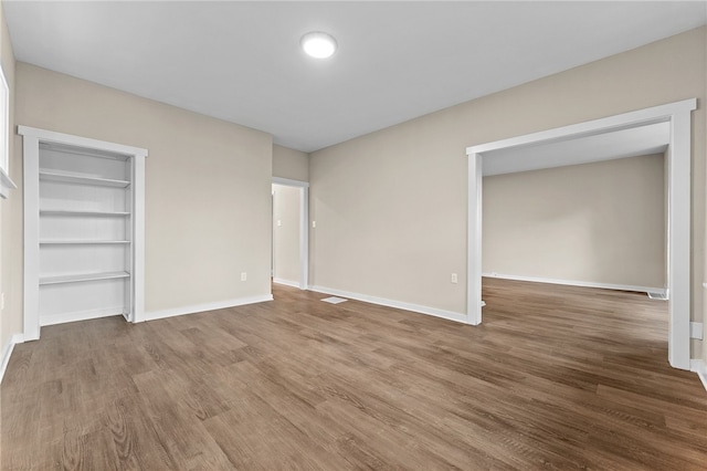 unfurnished bedroom featuring a closet and hardwood / wood-style floors