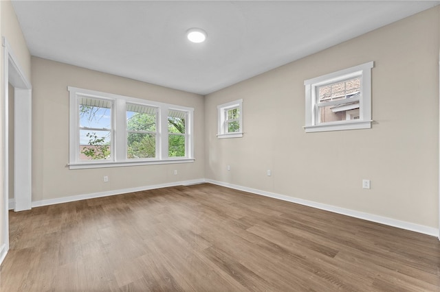 empty room with light hardwood / wood-style flooring