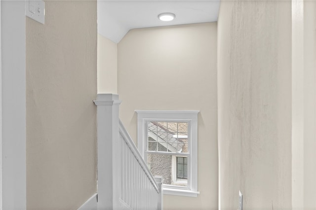 staircase featuring lofted ceiling