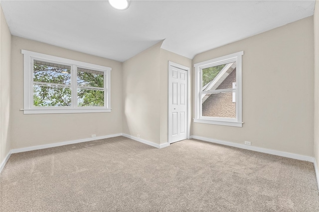 carpeted empty room with plenty of natural light