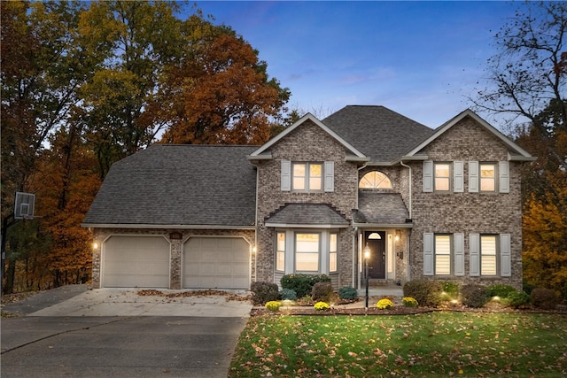 view of front of property featuring a yard and a garage