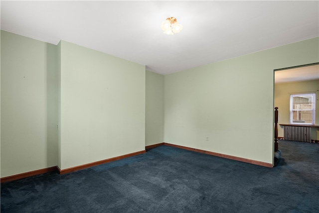 carpeted spare room with radiator heating unit