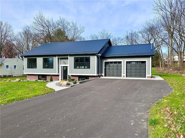 raised ranch with a garage and a front lawn