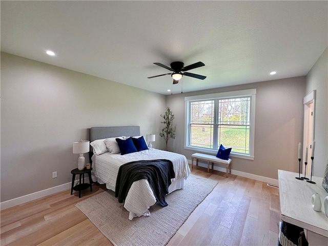 bedroom featuring ceiling fan and light hardwood / wood-style floors