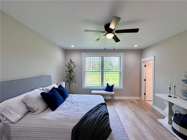 bedroom featuring ceiling fan and light hardwood / wood-style floors