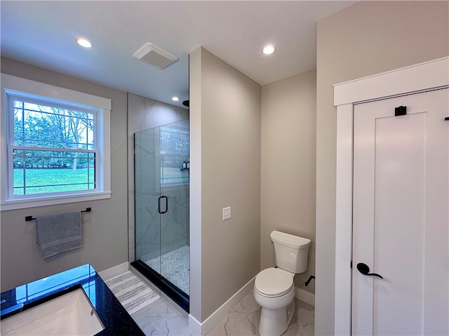 bathroom featuring a shower with door, vanity, and toilet