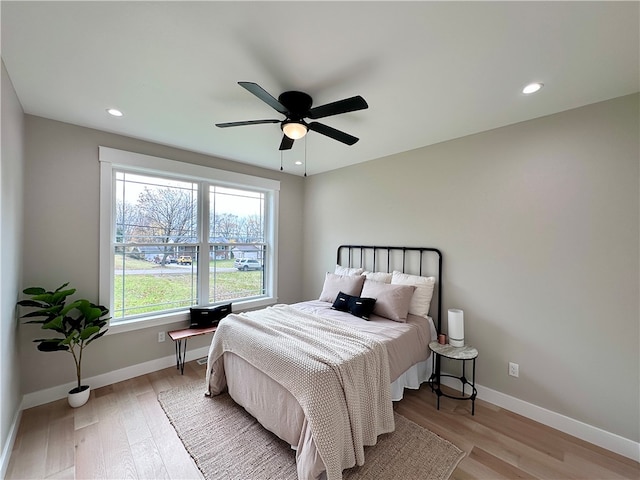 bedroom featuring light hardwood / wood-style floors and ceiling fan