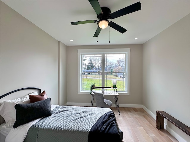 bedroom with ceiling fan and light hardwood / wood-style floors