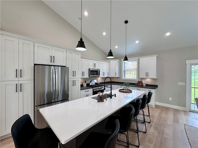 kitchen featuring white cabinets, a wealth of natural light, decorative light fixtures, and appliances with stainless steel finishes