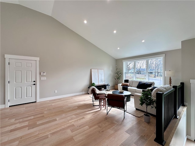 living room with high vaulted ceiling and light hardwood / wood-style floors