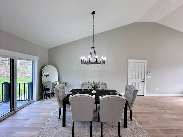 dining area featuring vaulted ceiling, light hardwood / wood-style flooring, and a notable chandelier