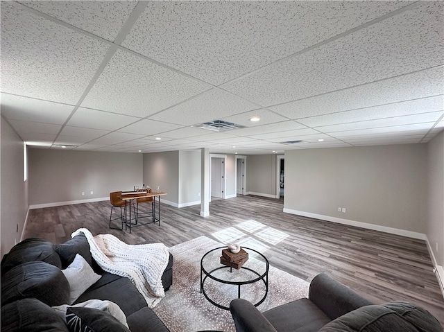 living room featuring a paneled ceiling and wood-type flooring