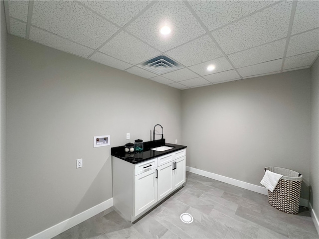 washroom featuring cabinets, hookup for a washing machine, and sink