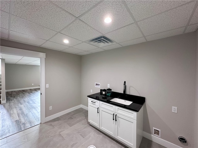 interior space featuring washer hookup, cabinets, sink, and light hardwood / wood-style flooring