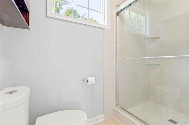 bathroom featuring an enclosed shower and toilet