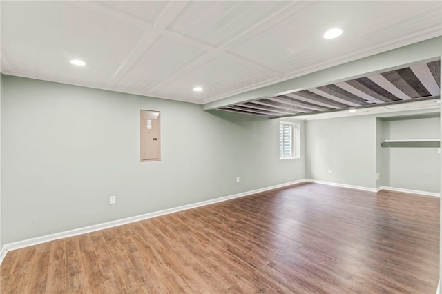 basement with electric panel and hardwood / wood-style flooring