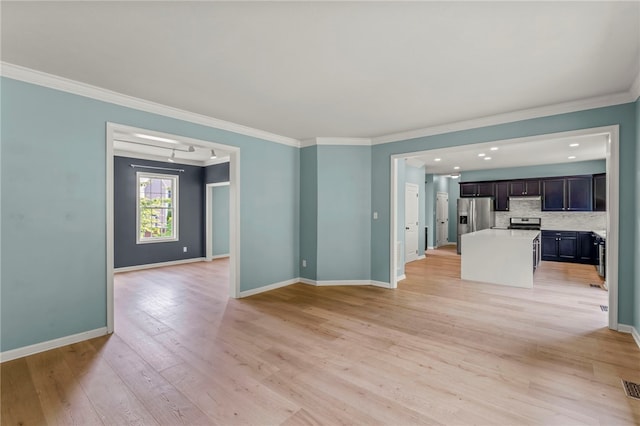 unfurnished living room with ornamental molding and light wood-type flooring