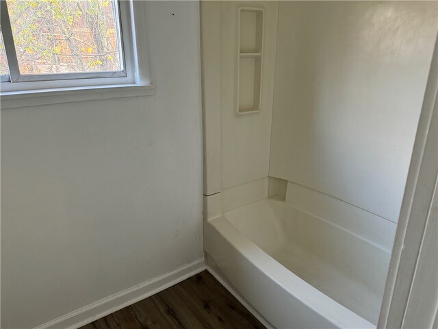 bathroom featuring a washtub and hardwood / wood-style floors