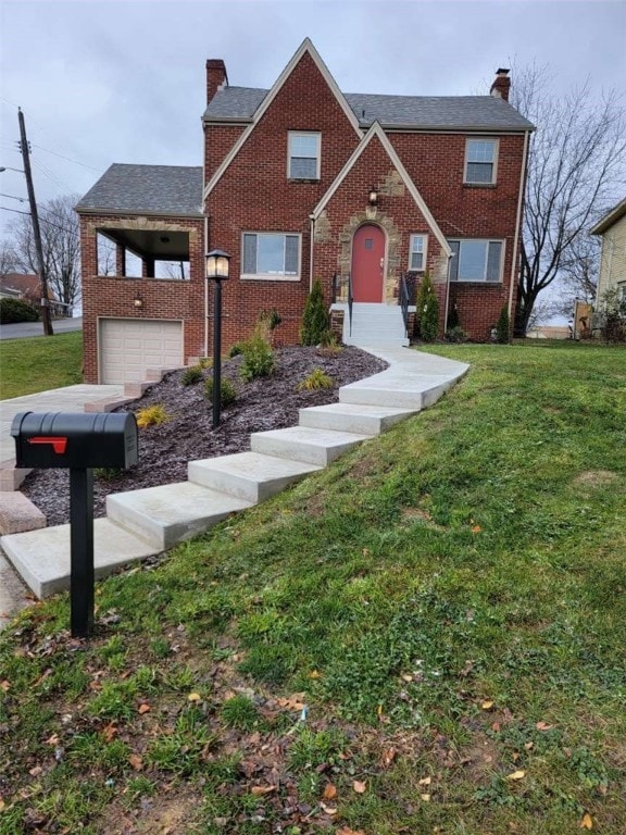 view of front of house with a garage and a front lawn