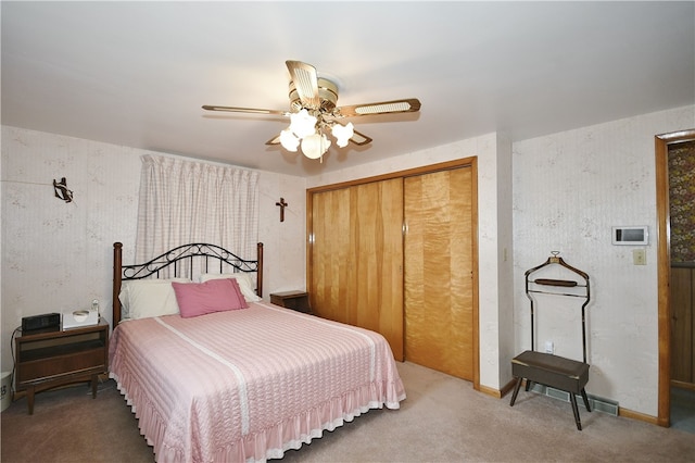 bedroom with ceiling fan, a closet, and carpet