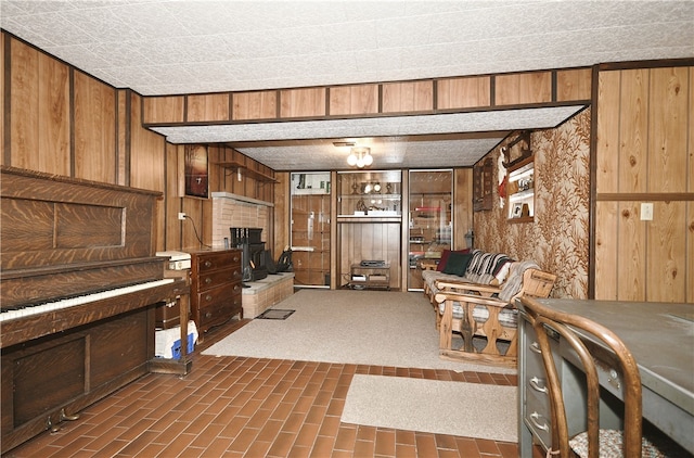 living room featuring wood walls and a fireplace