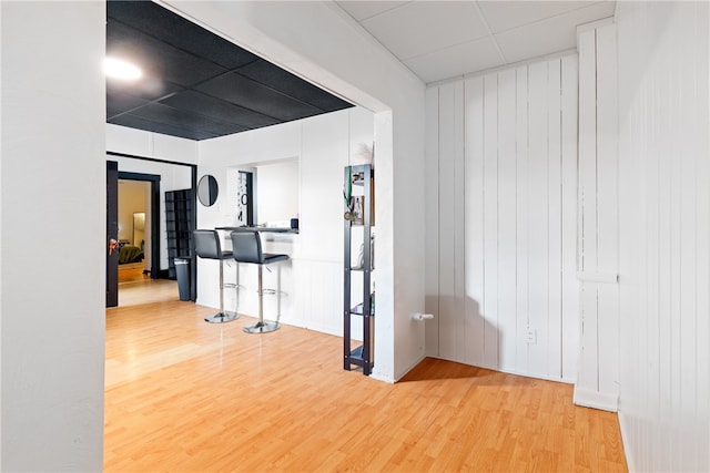 corridor with wood-type flooring and wooden walls