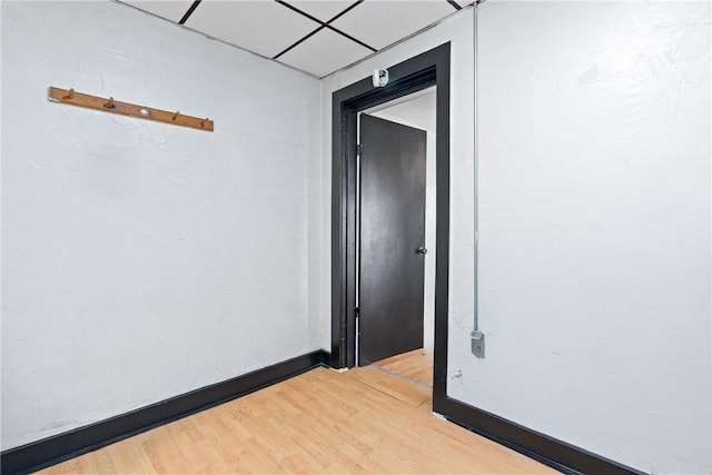 unfurnished room featuring a paneled ceiling and hardwood / wood-style floors