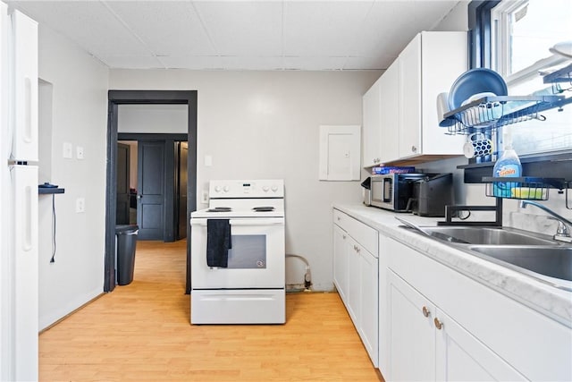 kitchen with white cabinetry, sink, white appliances, and light wood-type flooring