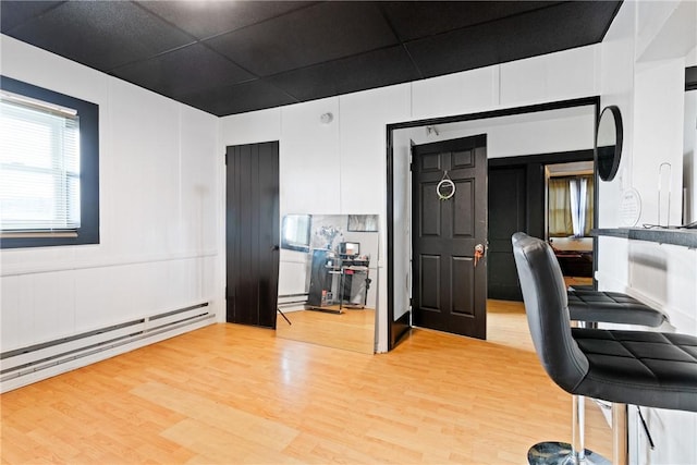 office area with light wood-type flooring and baseboard heating